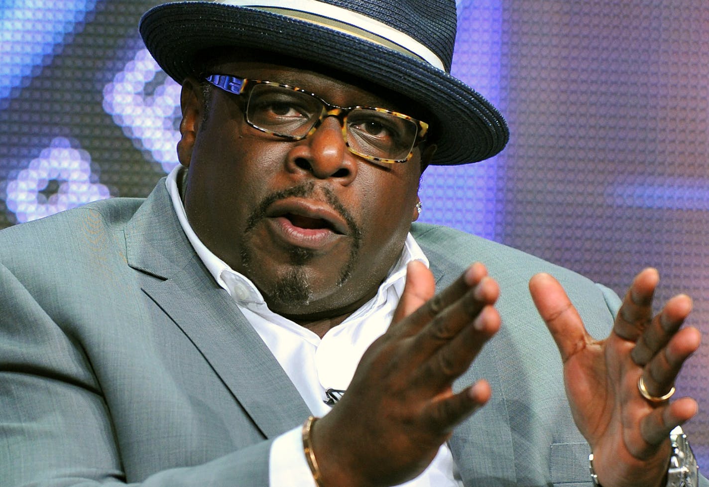 FILE - This Aug. 4, 2013, file photo, shows game show host Cedric "The Entertainer" of "Who Wants To Be A Millionaire" at the Disney/ABC Television Group's 2013 Summer TCA panel in Beverly Hills, Calif. On Sept. 2, the new season premieres, ushering in Cedric "The Entertainer" as host. (Photo by Vince Bucci/Invision/AP, File) ORG XMIT: MIN2013090414561849