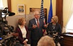 Gov.-elect Tim Walz, center, speaks during a news conference in the state Capitol Thursday, Nov. 8, 2018, in St. Paul, Minn., as Lt. Gov.-elect Peggy 