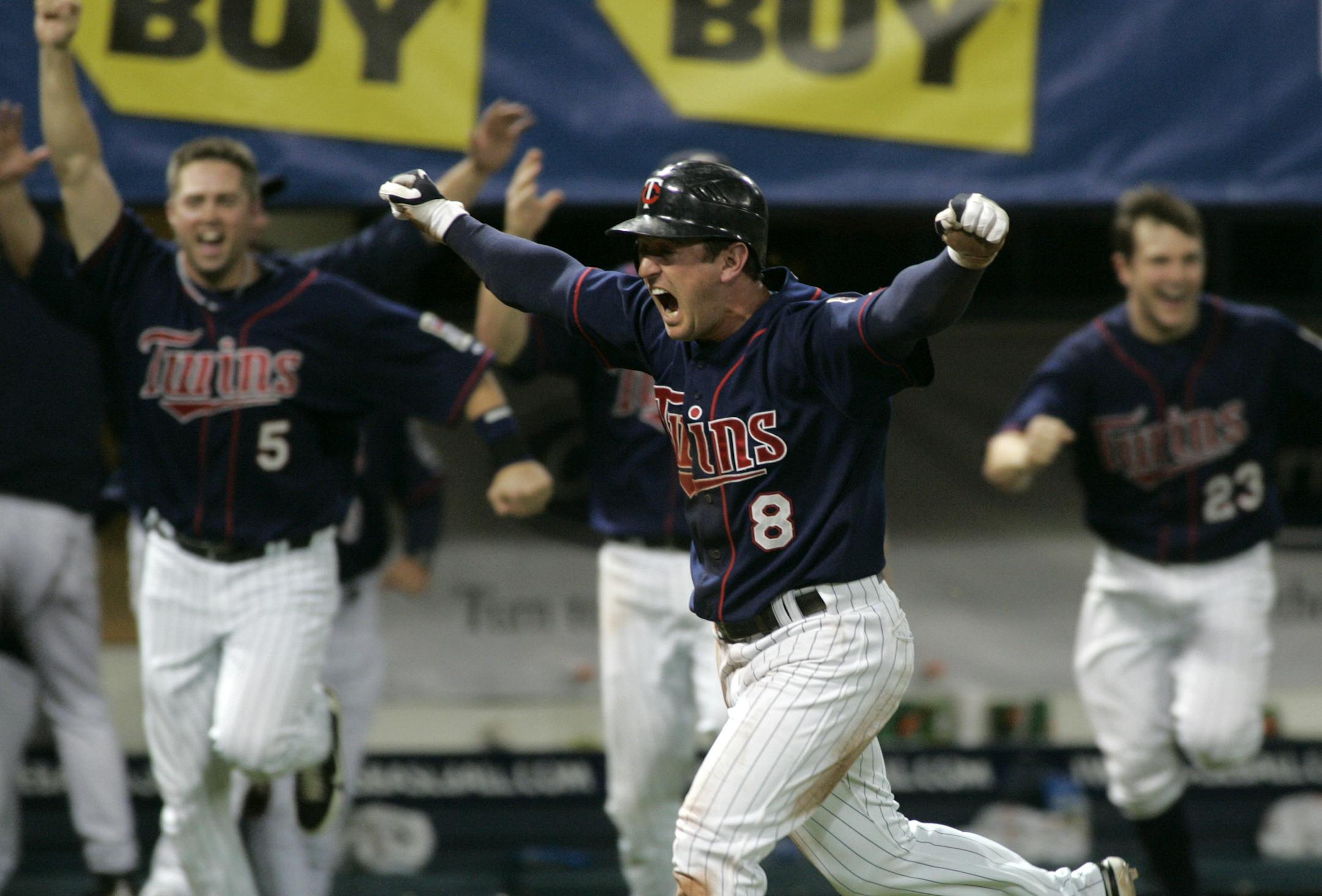 Minnesota Twins shortstop Nick Punto celebrates as he scores the winning run during the 10th inning of a baseball game against the Chicago White Sox on Thursday, Sept. 25, 2008 in Minneapolis. The Twins won 7-6.