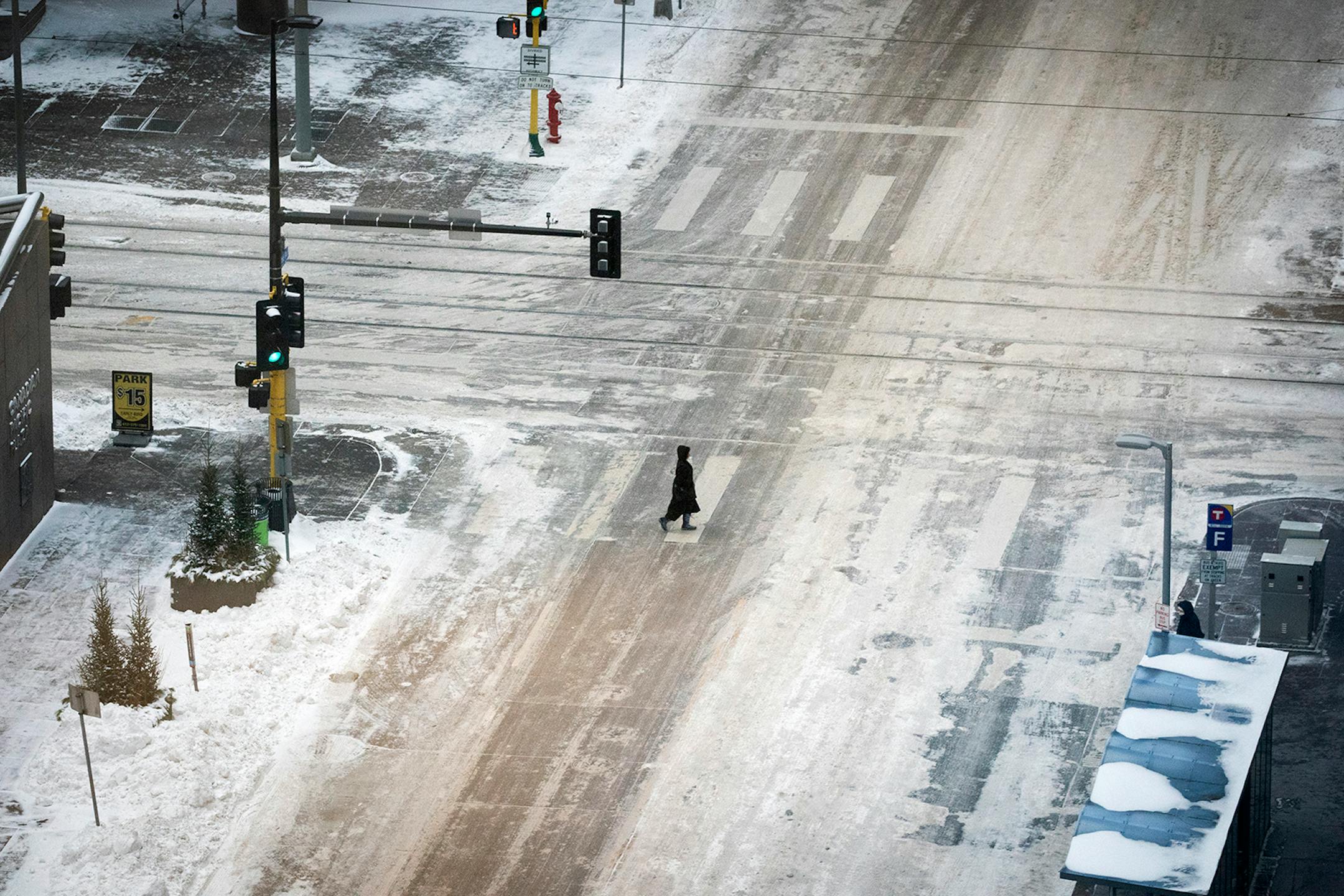 A pedestrian crosses 2nd Avenue at 6th Street in downtown Minneapolis during evening rush hour on January 29, 2019.
