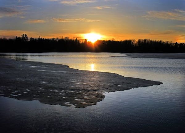 As the sun set on Lake Elora north of Duluth on Monday evening, the ice was breaking up. With Tuesday's sun, the ice officially disappeared by 5 p.m.