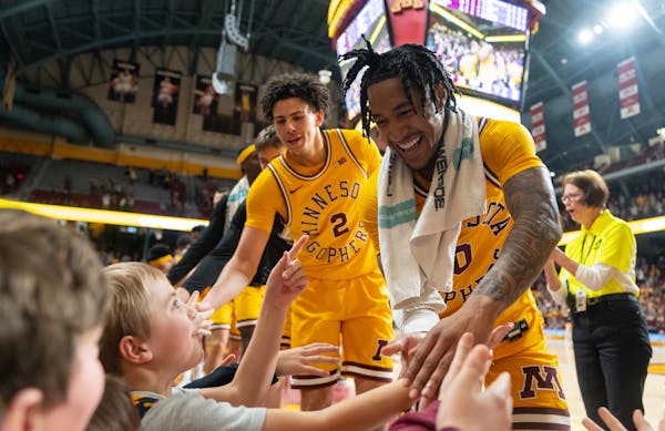 Gophers guards Mike Mitchell Jr. (2) and Elijah Hawkins (0) have become close friends since transferring from Pepperdine and Howard, respectively.