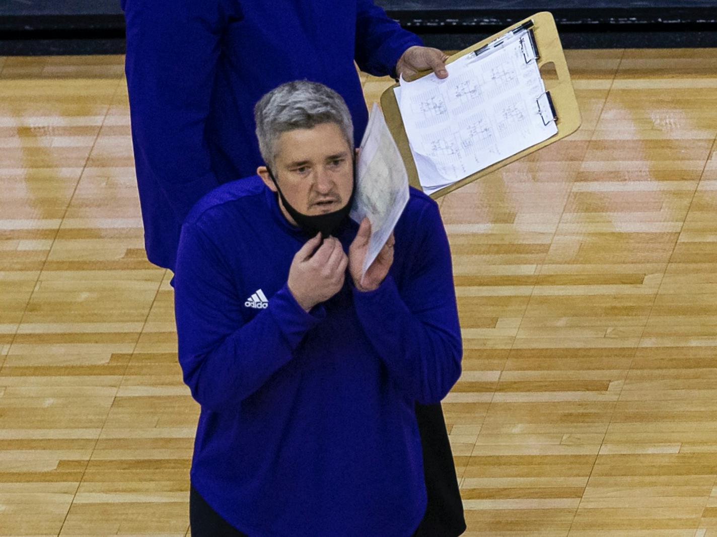 Washington head coach Keegan Cook talks to his player against Kentucky during a semifinal in the NCAA women's volleyball championships Thursday, April 22, 2021, in Omaha, Neb. (AP Photo/John Peterson)