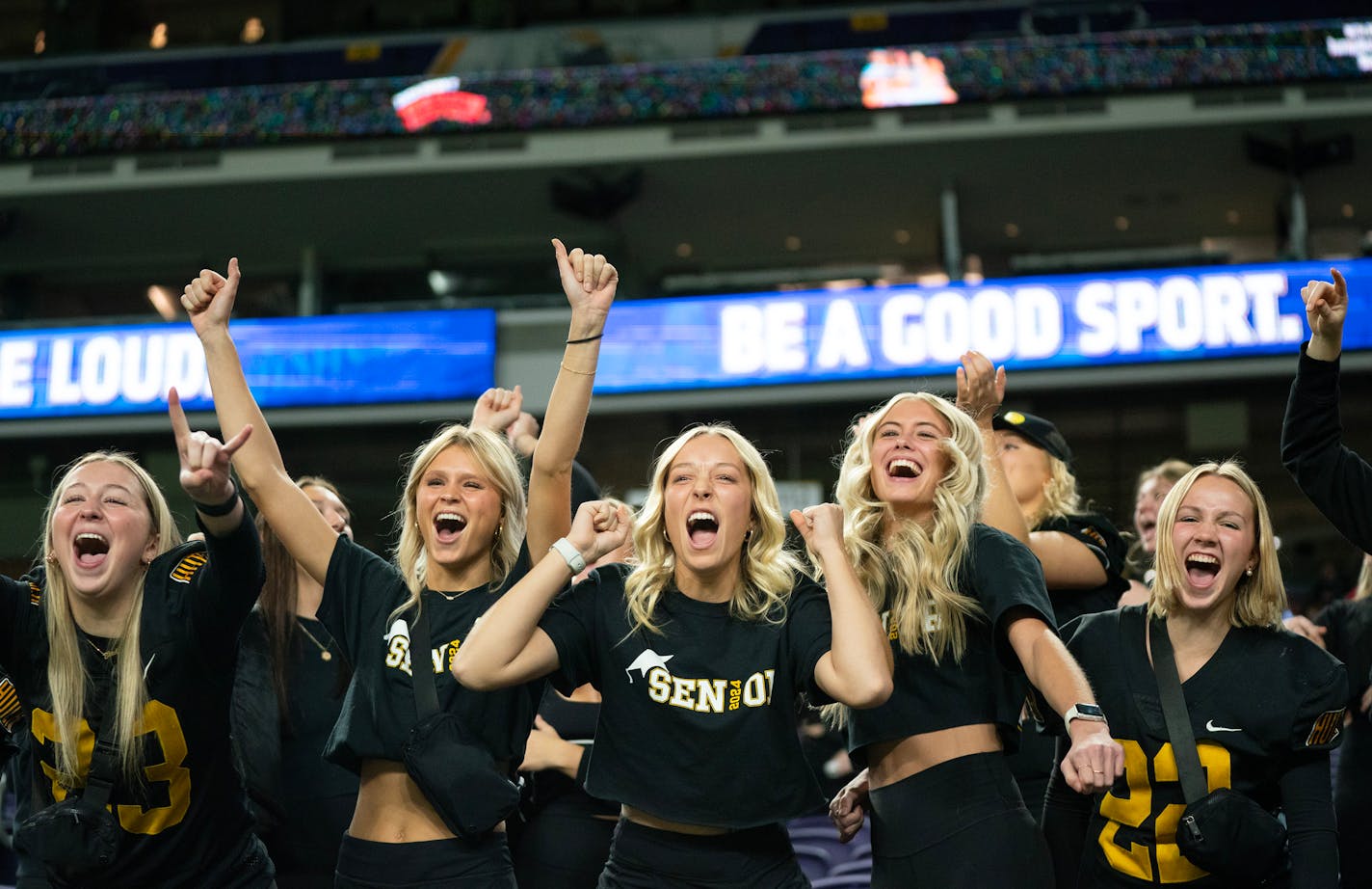 The Hutchinson student section celebrates as the clock runs out on their team's 56-28 victory over North Branch in a Class 4A football semi-final game Friday, Nov. 17, 2023, at U.S. Bank Stadium in Minneapolis, Minn. ]