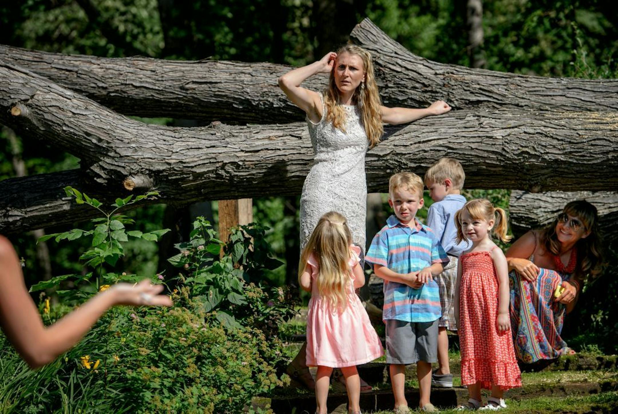 Bride Brianna Sucik worked out the oder of the wedding party during rehearsal for their Saturday wedding next to the 90-foot fallen maple that crashed down on her mother and stepfather's roof during the storm.