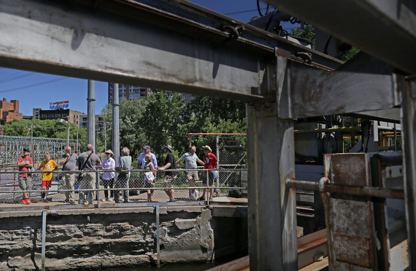 One of two tour guides, Rod Richter, gray shirt back to camera, talks about Xcel Energy&#x2019;s Hennepin Island Hydroelectric Plant. The plant is still in service, having first produced electricity in 1908.