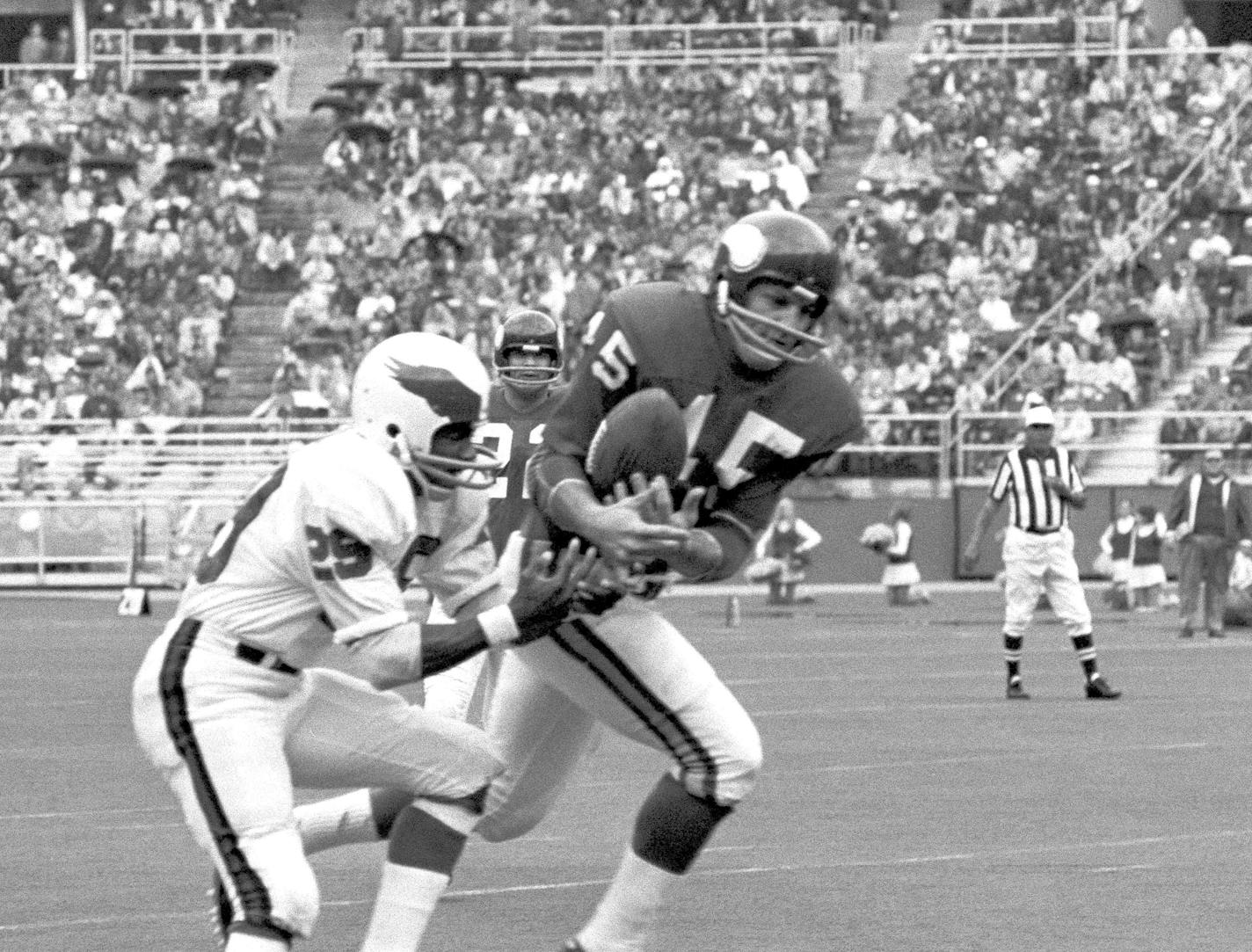 Ed Sharockman, Minnesota Vikings defensive back grabs pass intended for Philadelphia Eagles wide receiver Harold Jackson (29) on the 40-yard line and then ran it back to the Eagles 5-yard line in second period of Vikings - Eagles pro-football game in Philadelphia on Sunday, Oct. 10, 1971. The interception set up touchdown by Vikings running back Dave Osborn. Vikings won, 13-0. (AP Photo/Bill Ingraham)