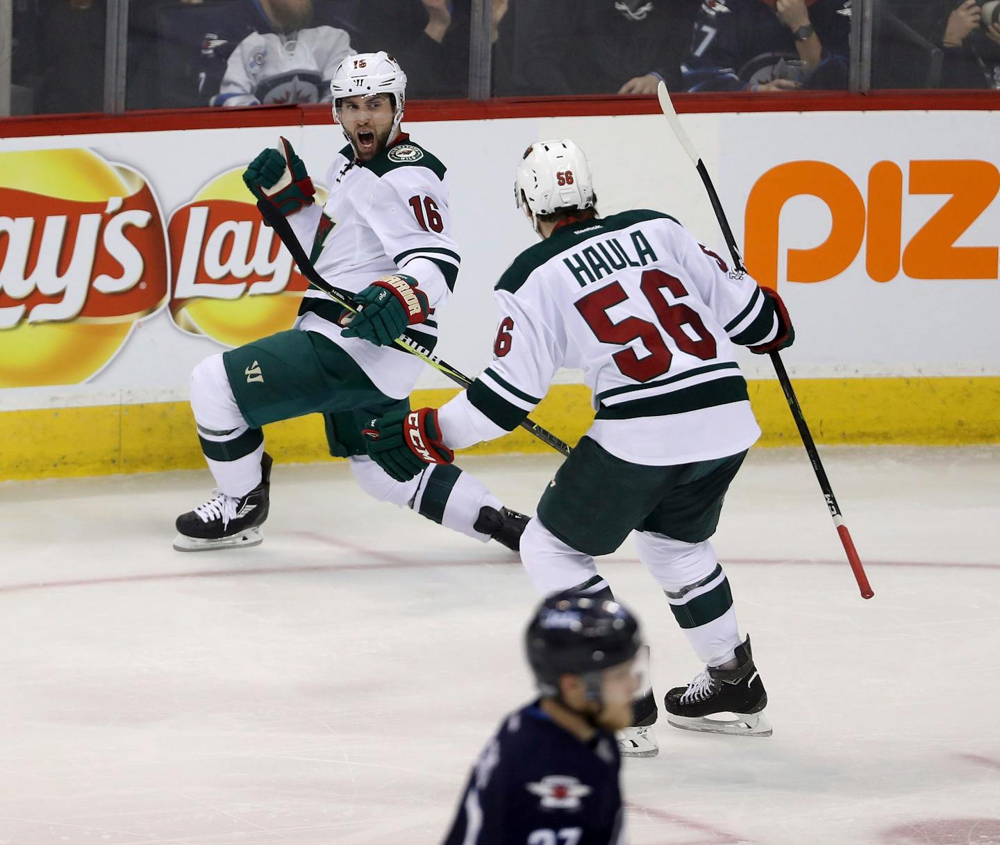 Minnesota Wild's Jason Zucker (16) celebrates with Erik Haula (56) after Zucker scored against the Winnipeg Jets during the third period of an NHL hockey game Tuesday, Feb. 28, 2017, in Winnipeg, Manitoba. (Trevor Hagan/The Canadian Press via AP)