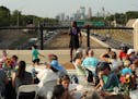 Minneapolis City Council Vice President Andrea Jenkins spoke as neighbors gathered for a family style dinner during the Building Bridges and Breaking 