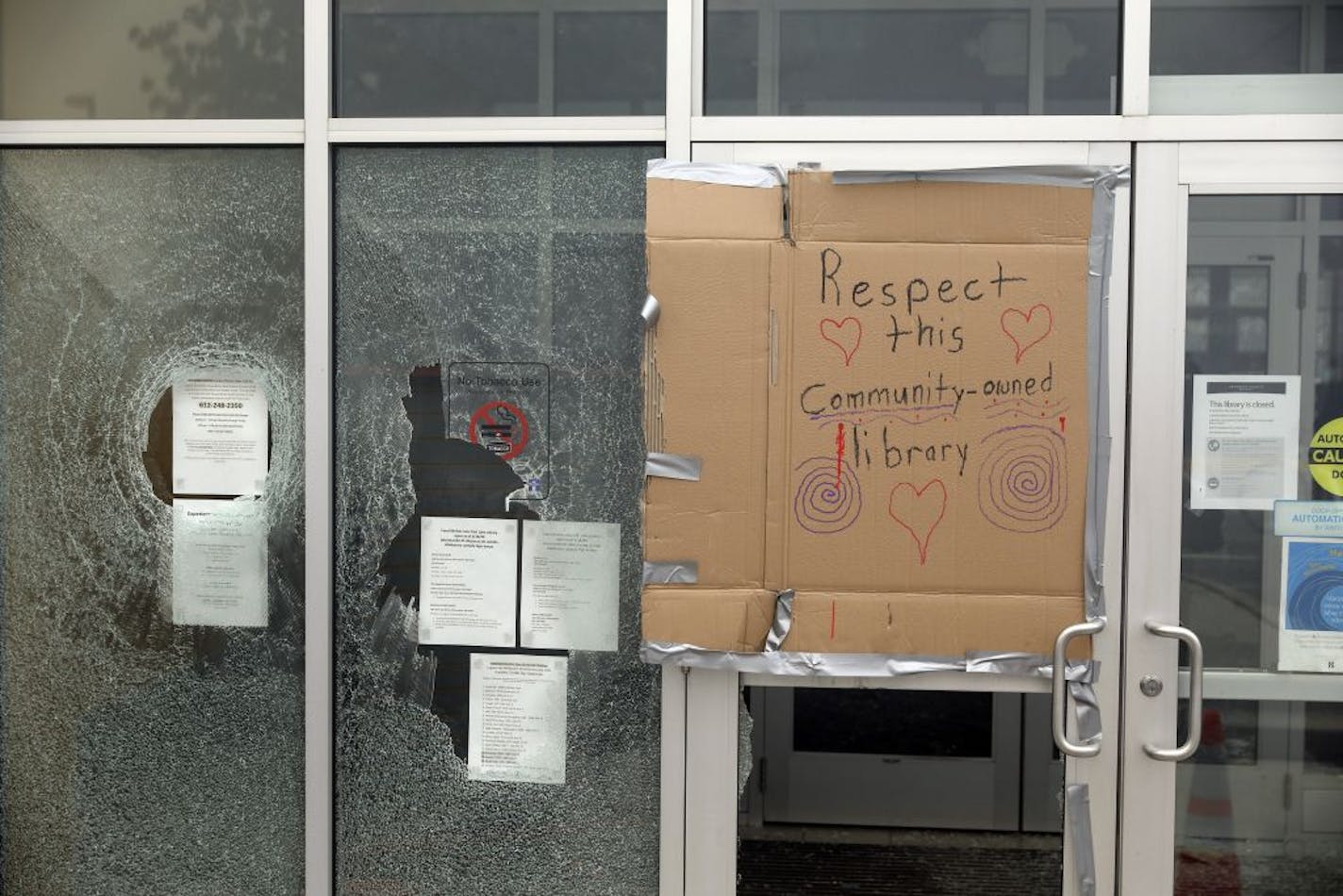 A vandalized library in Minneapolis, on Friday, May 29, 2020. A Minneapolis police station was overrun and set ablaze by protesters Thursday night as destructive demonstrations raged in the city and spread across the country overnight Friday after the death of George Floyd, an African-American man, in police custody.