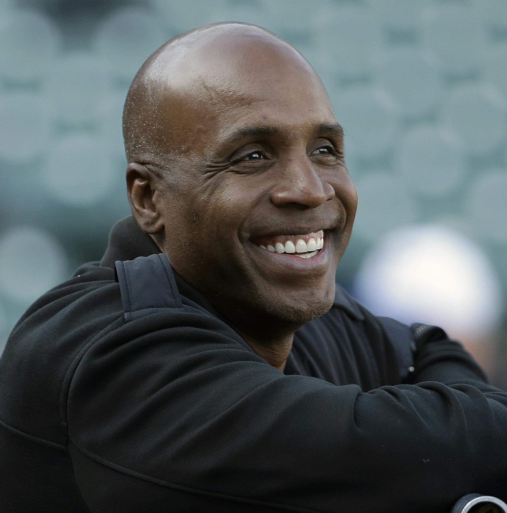 FILE - In this Aug. 25, 2015, file photo, former baseball player Barry Bonds smiles before a baseball game between the San Francisco Giants and the Chicago Cubs in San Francisco. Steroids-tainted home run king Barry Bonds is returning to baseball full time as hitting coach for the Miami Marlins. (AP Photo/Jeff Chiu, File)