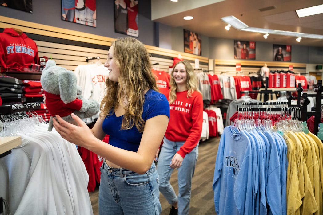 Twins Courtney and Emily Goude walk through the bookstore at the College of St. Benedict before the start of the school year. They both have been working on campus ever since moving to St. Joseph in June.