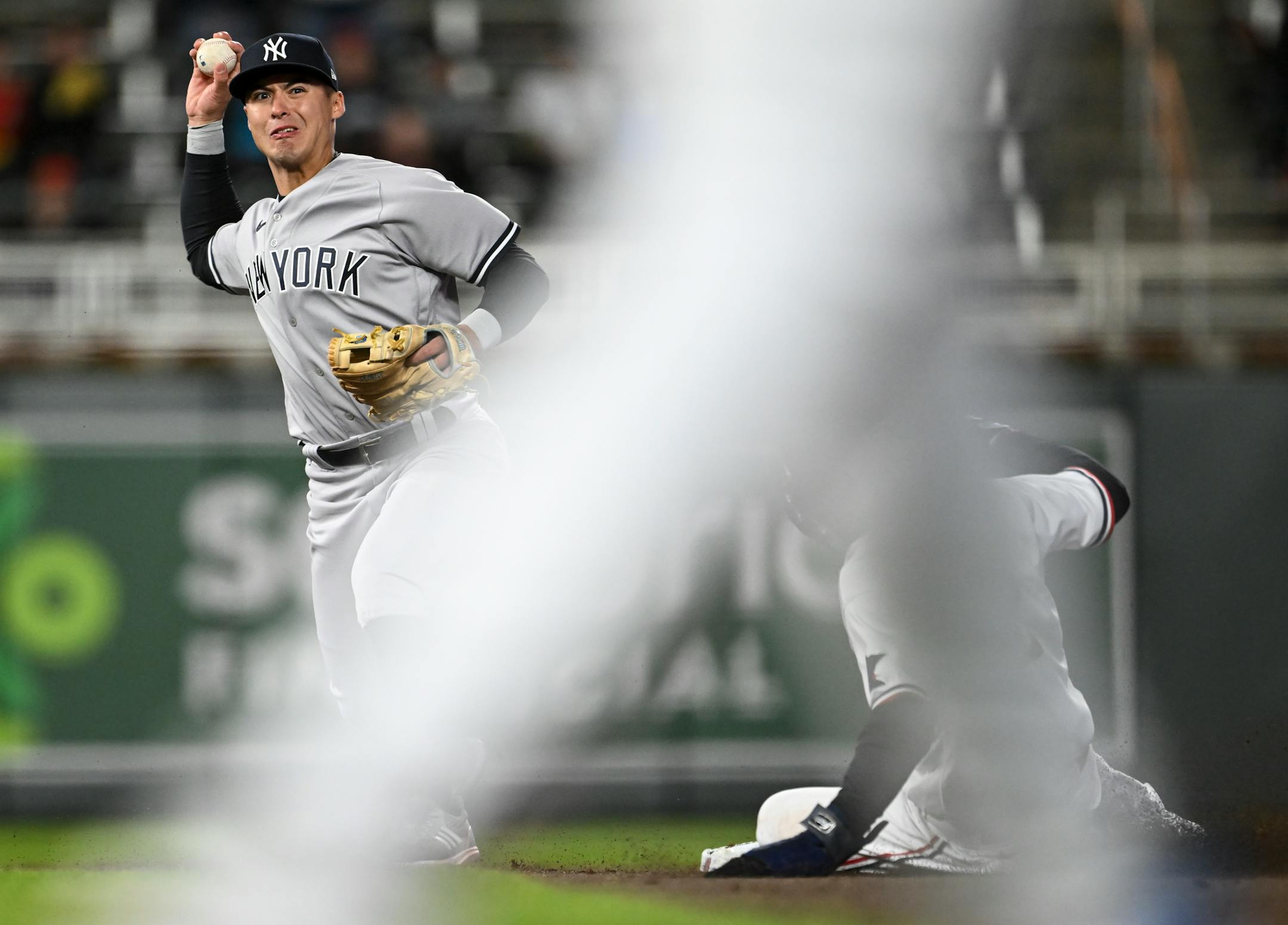 Minnesota Twins center fielder Michael A. Taylor is out at second as New York Yankees shortstop Anthony Volpe tries to throw right fielder Max Kepler out after a hit at first, but commits a throwing error Monday.