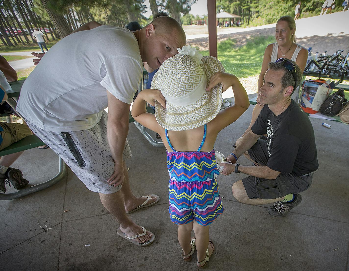 Shaun Floerke, right, checked in with defendants and their families including Shawn Wirta during a picnic his office organized with DWI defendants in July in Duluth.