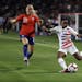 The U.S. national team's Crystal Dunn, right, in an international friendly last August in Carson, Calif., also plays midfielder for the NWSL champion 
