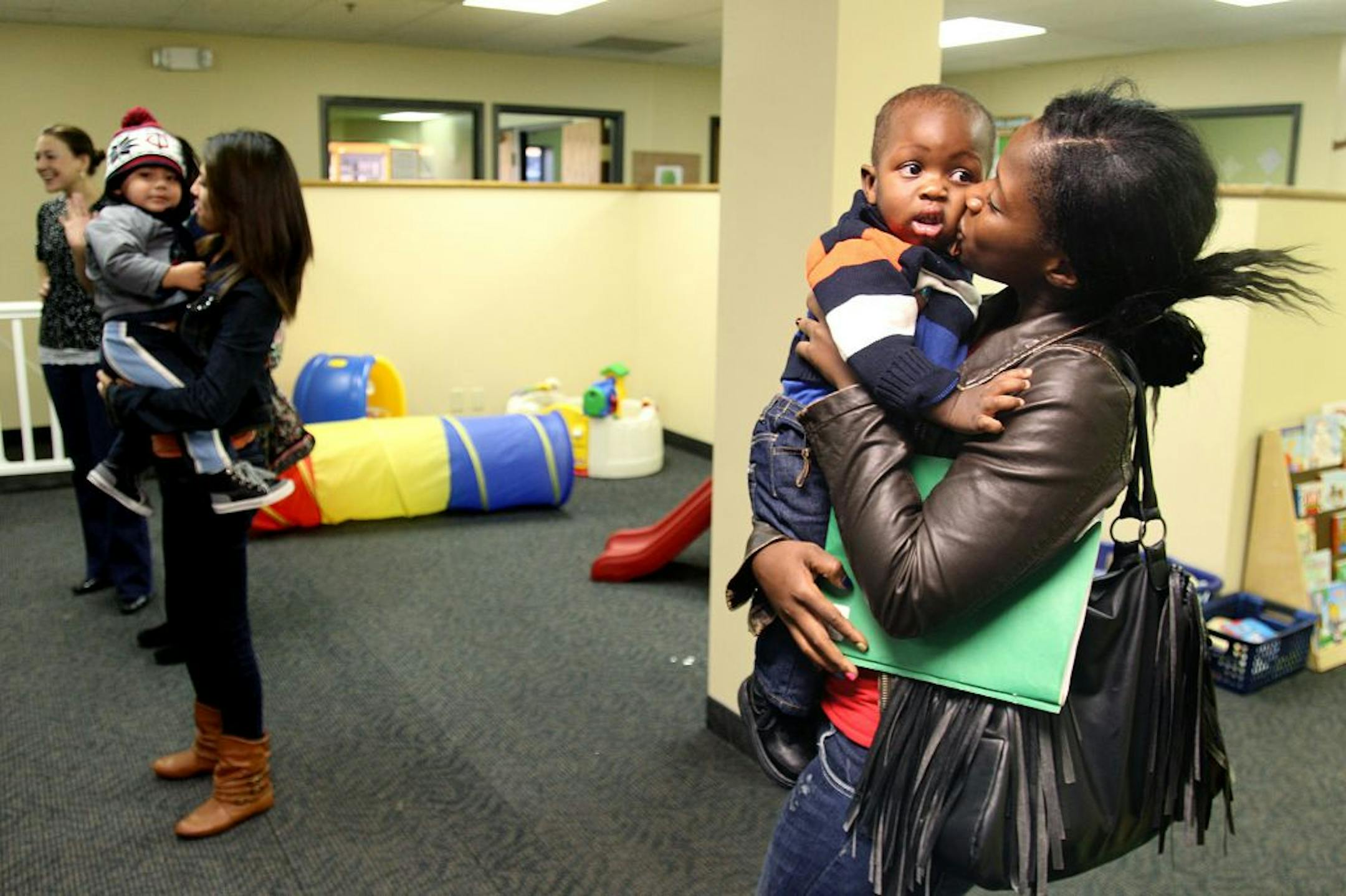 Brooklyn Center Academy students Elvira Alvarado, left, and Delphine Kamara greeted their children at the end of the school day.