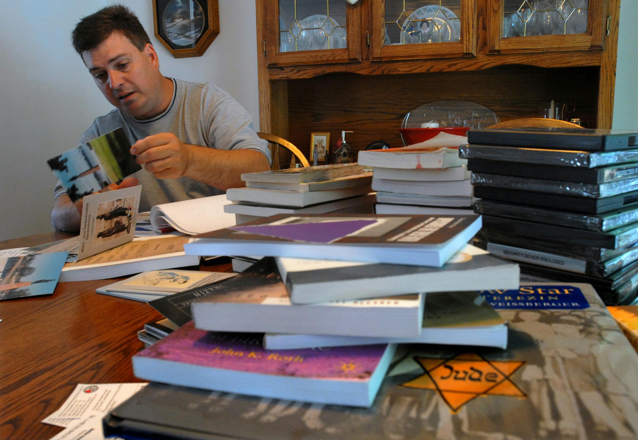 Tom Franta, who teaches social studies at Irondale High School in Mounds View, looked through material he has collected (some from his travels to Holocaust sites) for the Holocaust/genocide course he will teach.