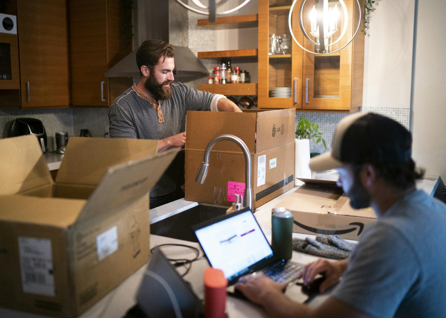 Erik McLaughlin packed up his kitchen as he and his roommate Dave Claridge, at right, prepared for their move from an Uptown apartment to the North Loop in Minneapolis, Minn, on Thursday, September 10, 2020. ] RENEE JONES SCHNEIDER renee.jones@startribune.com