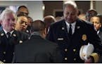 Minneapolis Fire Chief John Fruetel and Assistant Chief Bryan Tyner at the funeral service for longtime Minneapolis civil rights activist Ron Edwards 