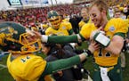 North Dakota State quarterbacks Carson Wentz (11) and Easton Stick (12) celebrate after they defeated Jacksonville State 37-10 in the FCS championship