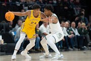 Gophers guard Cam Christie, left, fends off Michigan State guard A.J. Hoggard during Thursday's Big Ten tournament game at Target Center.