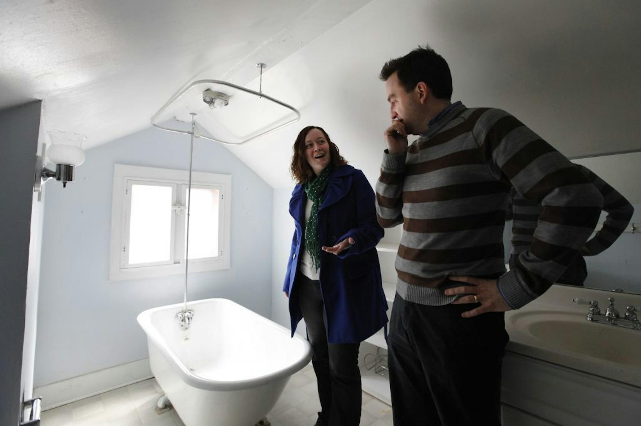 In this Tuesday April 2, 2013, photo, Christian Bell and his wife Beth Heinen Bell view a home for sale in Grand Rapids, Mich. The housing shortage around Grand Rapids, Mich., a city known for its furniture-making industry and sleek downtown hospital complex, is fairly typical of what the country as a whole is facing this spring. Like so many others, Grand Rapids never experienced the oversupply or the massive price collapse that marked the recent boom and bust. Yet it, too, was affected.