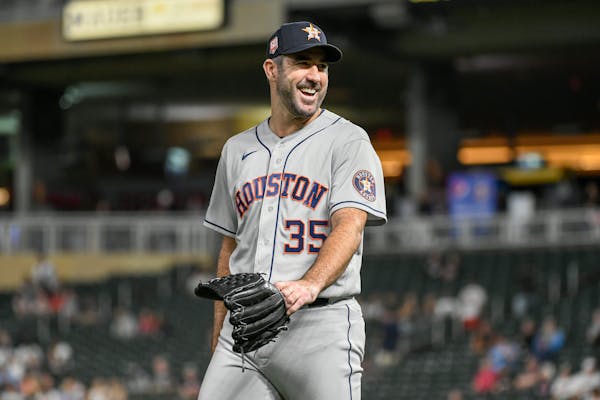 Houston Astros pitcher Justin Verlander smiles as he heads to the dugout after completing eight innings and allowing the Minnesota Twins only one hit 
