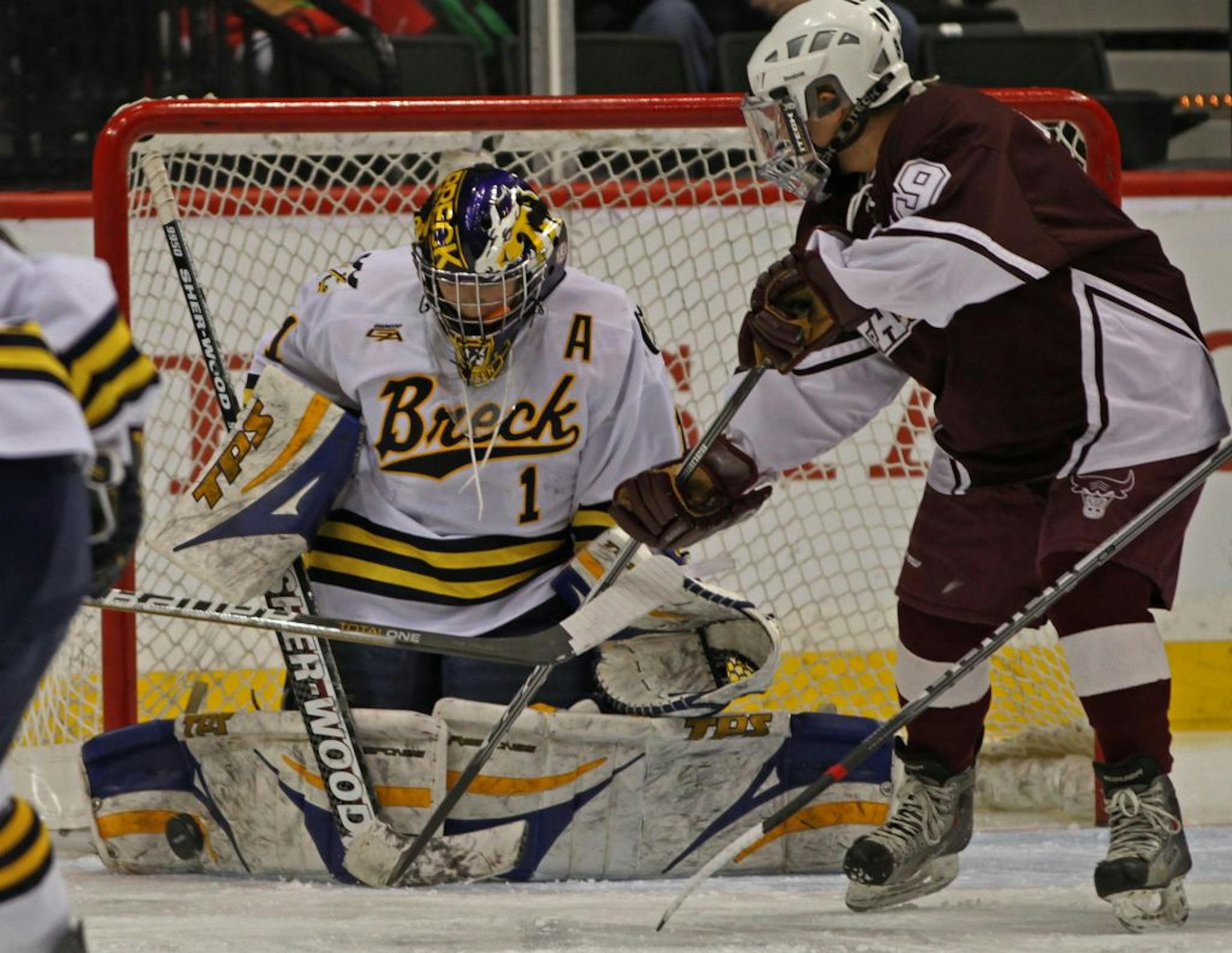 Girls State Hockey Tournament, Class A Championship, Breck vs. South St. Paul. 2/25/12. (left to right) Breck goalie Taylor Neisen stopped South St. Paul's Emily Reibert's shot on goal in first period action.