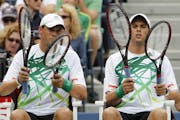 A file photo of top-seeded Bob Bryan, left, and Mike Bryan, made their earliest exit from the Australian Open in 11 years, losing to American Eric But