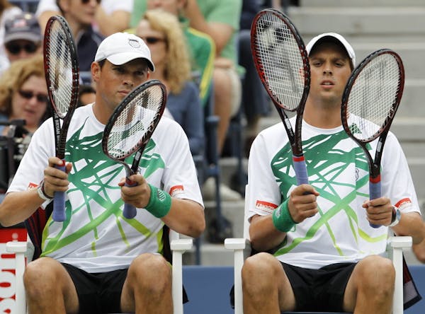 A file photo of top-seeded Bob Bryan, left, and Mike Bryan, made their earliest exit from the Australian Open in 11 years, losing to American Eric But