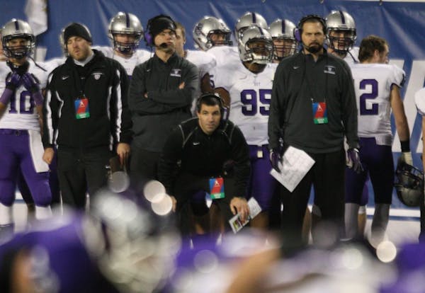 St. Thomas head coach Glenn Caruso, center, watches his team during the second half of the NCAA Division III football championship against Mount Union