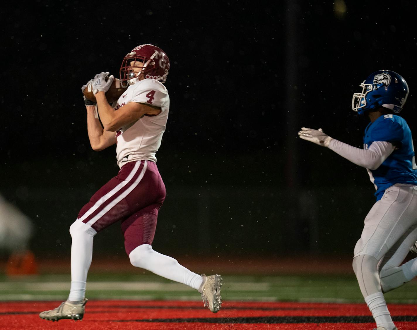 Maple Grove wide receiver Sam Peters (4) snared a second quarter pass for an 82 yard touchdown play Thursday, Nov. 11, 2021 in Eden Prairie. The Maple Grove Crimson faced the Woodbury Royals in a MSHSL Class 6A football state tournament quarterfinal game Thursday, Nov. 11, 2021 night at Eden Prairie High School in Eden Prairie. ] JEFF WHEELER • Jeff.Wheeler@startribune.com