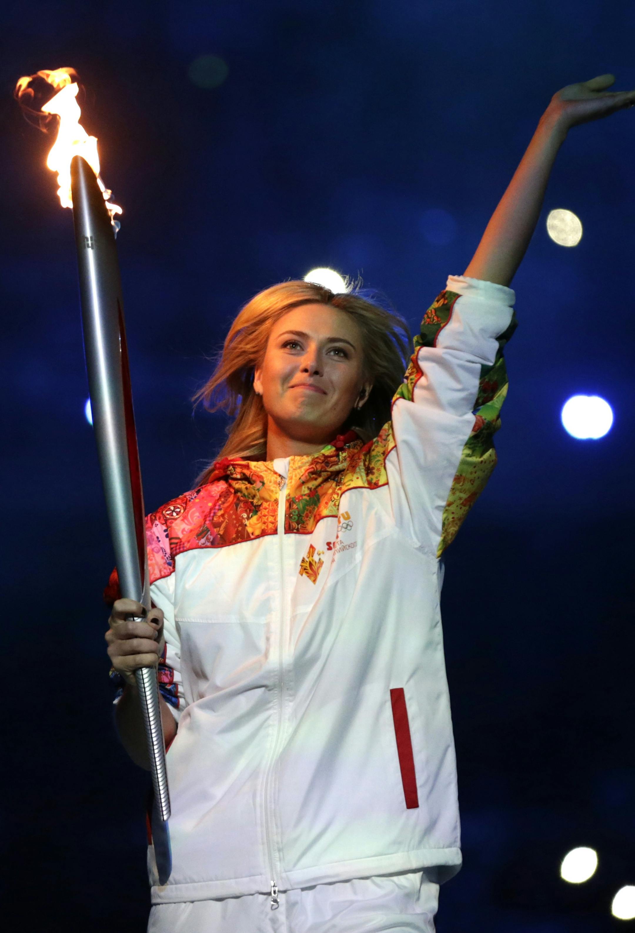 Russia's Maria Sharapova carries the torch during the opening ceremony of the 2014 Winter Olympics in Sochi, Russia, Friday, Feb. 7, 2014. (AP Photo/Matt Dunham)