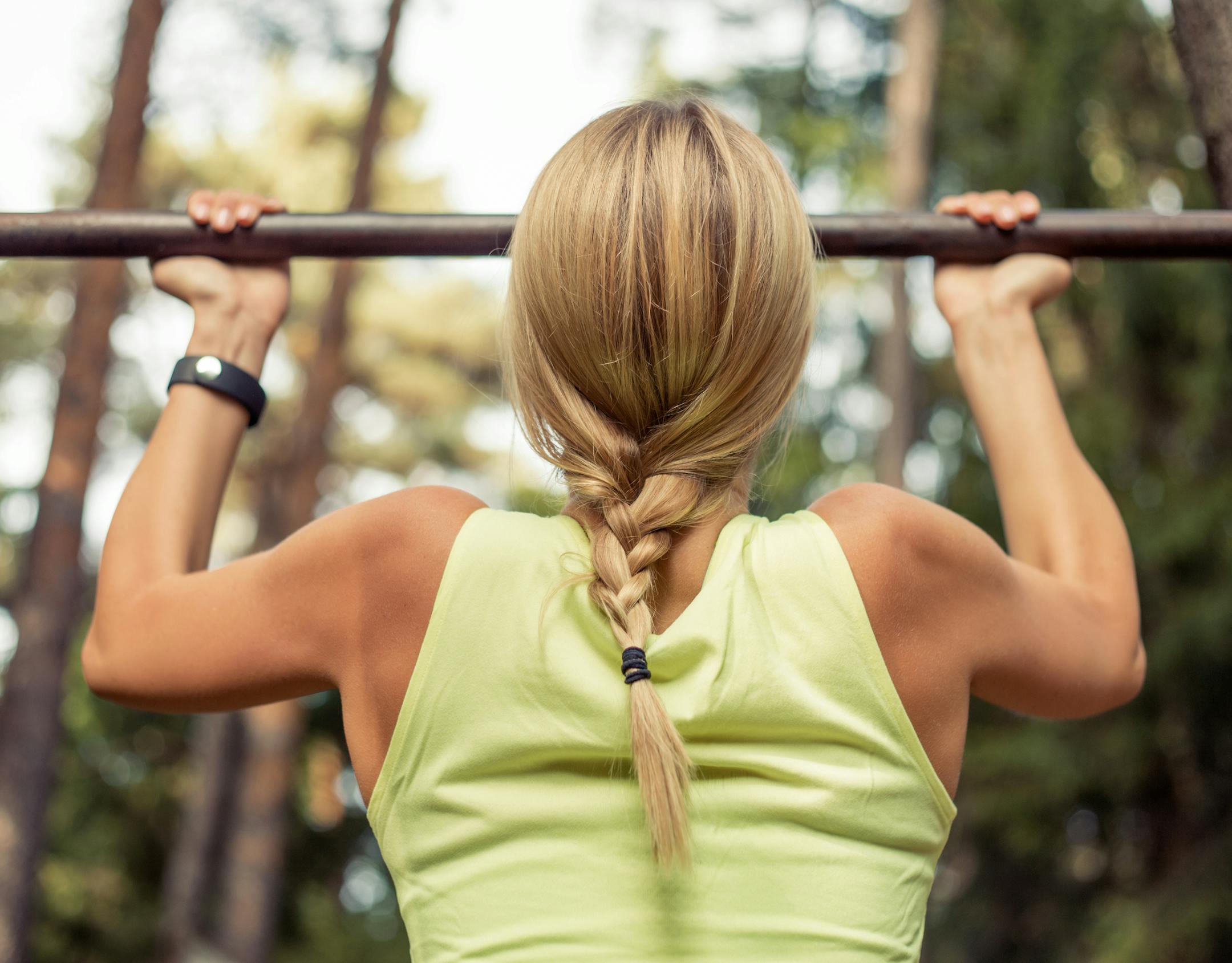 Fit and strong woman doing pullups, chinups istock photo