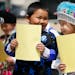Derick Vang left and Lina Lee first graders at Jackson Elementary school in St. Paul, performed folk poetry at the Hmong American Day celebration Wedn