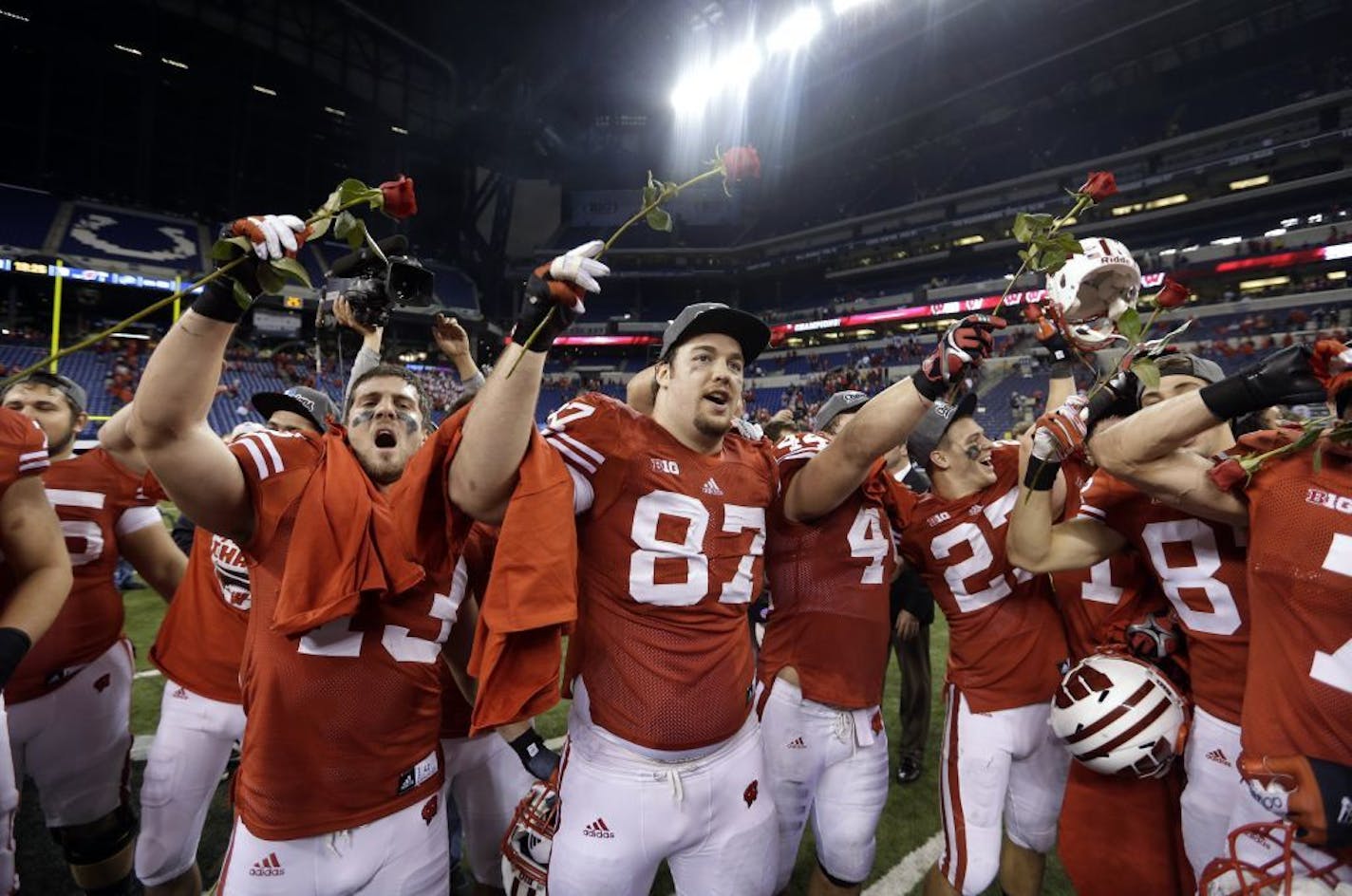 Wisconsin players celebrate after defeating Nebraska 70-31 to win the Big Ten championship.