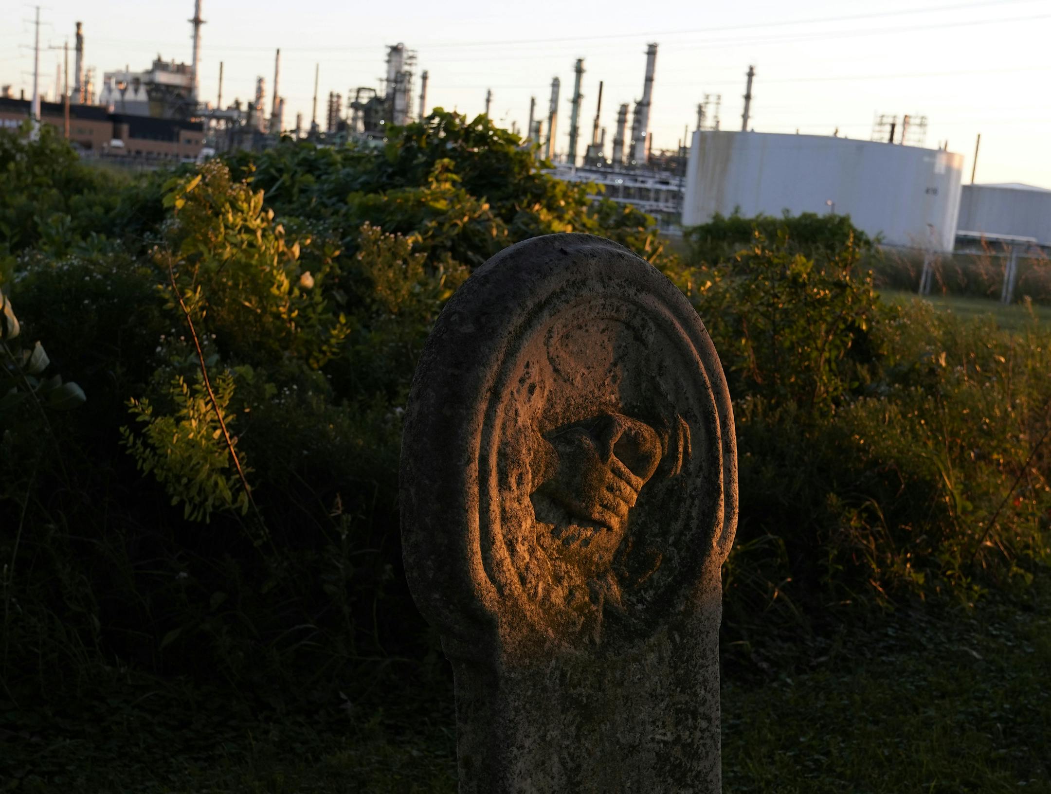 Rays of light from the setting sun illuminated a old grave marker, the name of the deceased long ago worn away by the elements in Pine Bend Cemetery, which sits next to Pine Bend Refinery, owned by Koch Industries. Pine Bend Refinery has grown and company property now surrounds the cemetery, making access to the cemetery difficult and its future uncertain and seen Thursday, Sept. 3, in Rosemount. ] DAVID JOLES • david.joles@startribune.com Thursday, Sept. 3, 2020 in Rosemount, MN. east burb stor