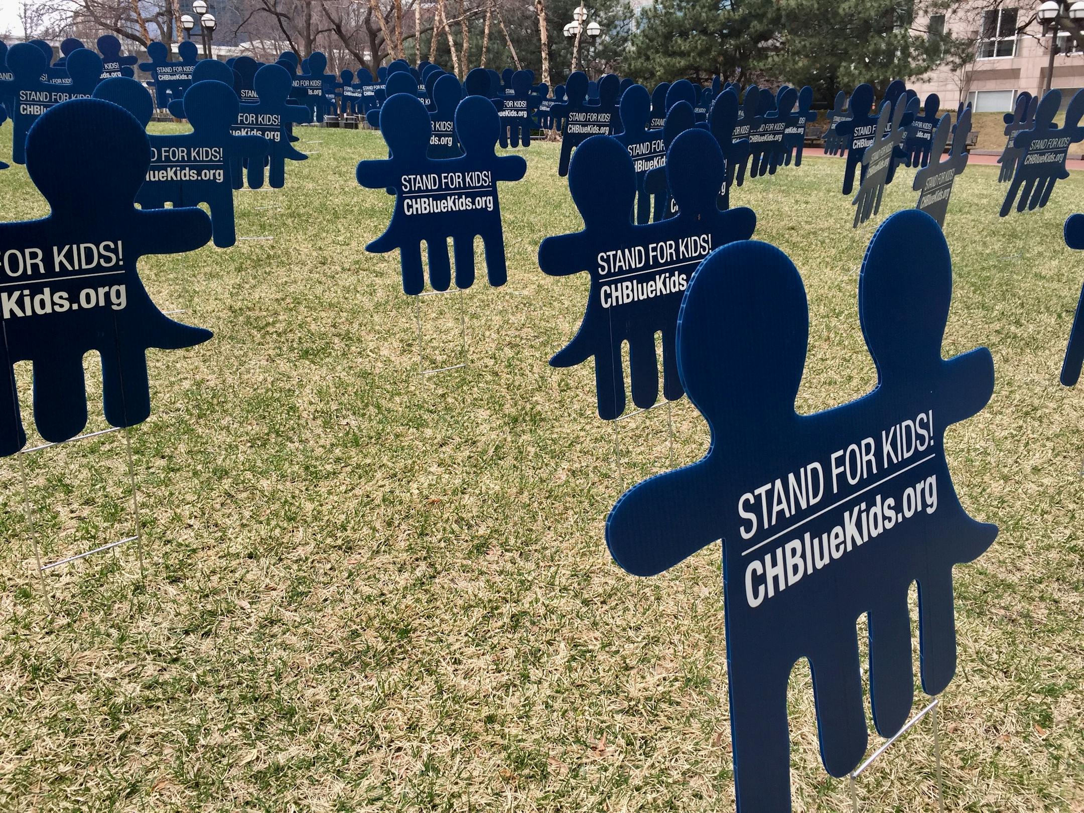 Leaders from Hennepin County and Minneapolis nonprofit CornerHouse planted about 100 signs on April 5, 2017 in front of the Hennepin County Government Center to represent the thousands of children abused in Minnesota each year.