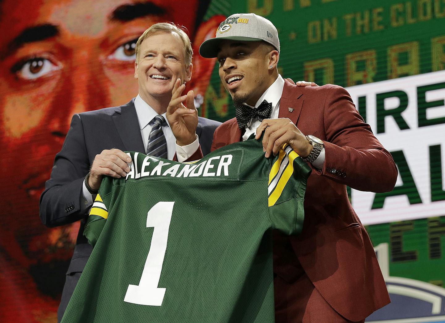 Commissioner Roger Goodell, left, presents Louisville's Jaire Alexander with his Green Bay Packers jersey during the first round of the NFL football draft, Thursday, April 26, 2018, in Arlington, Texas. (AP Photo/David J. Phillip)