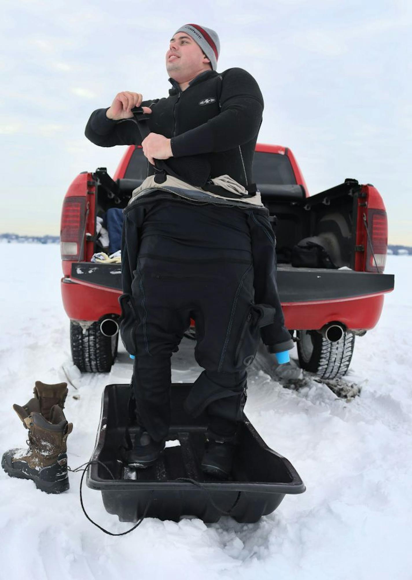 Members of the Great Lakes Shipwreck Preservation Society dove under the ice on Lake Minnetonka to take video of a shipwreck that they'll use to create a 3-D image of a boat wreck there Saturday, Feb. 16, 2019, near Carson Bay in Wayzata, MN. Here, GLSP diver Andrew Goodman gets his dry suit on for a dive.