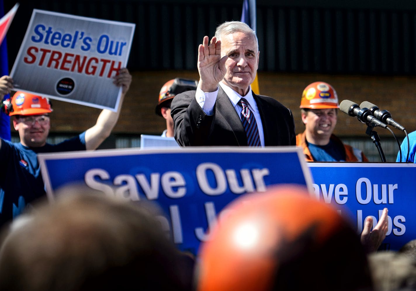 Iron Miners listened to Gov. Mark Dayton at a rally in Virginia against alleged illegal steel dumping from Asian countries.