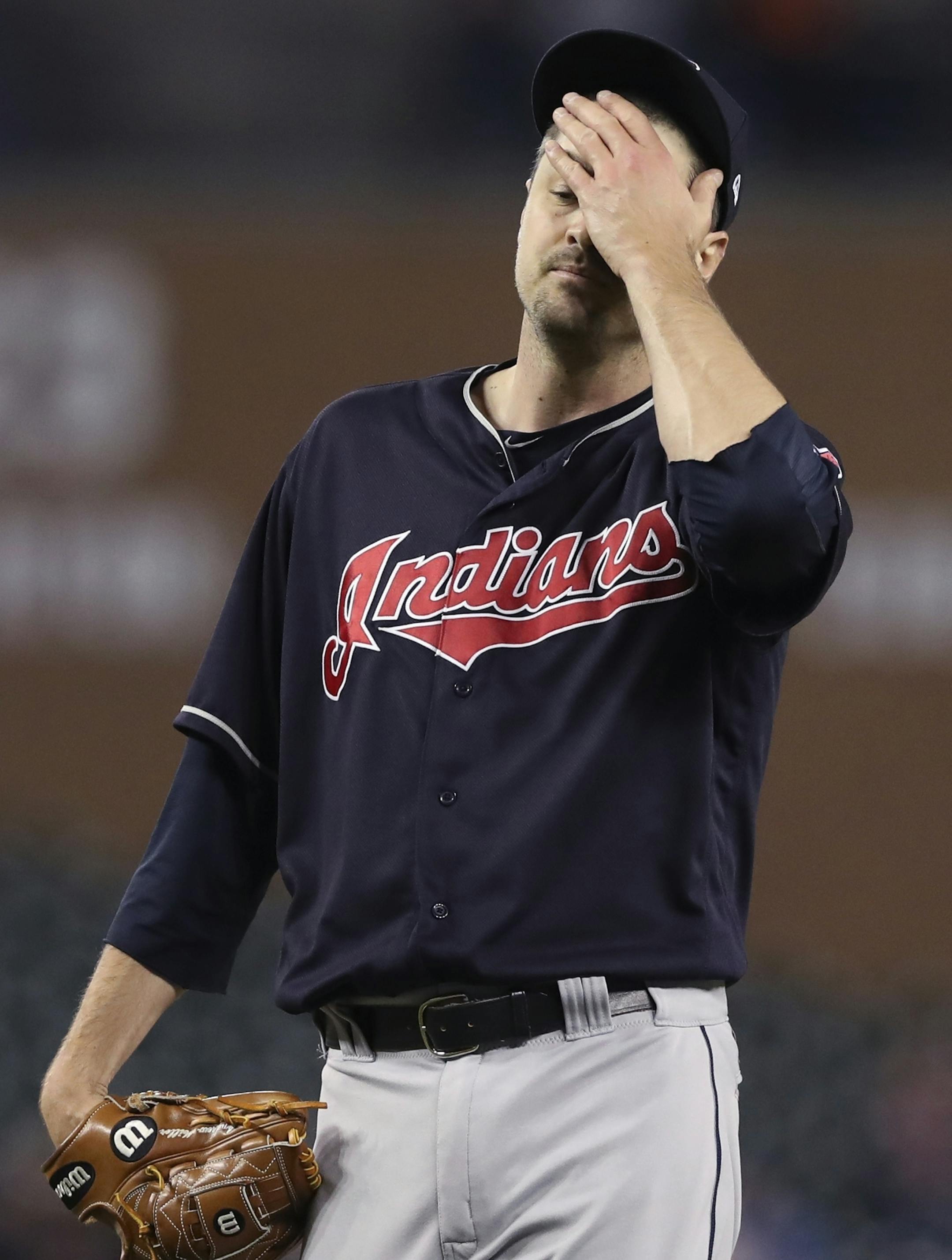 Cleveland Indians relief pitcher Andrew Miller wipes his face after giving up a bases loaded walk during the seventh inning of a baseball game against the Detroit Tigers, Tuesday, May 15, 2018, in Detroit. (AP Photo/Carlos Osorio) ORG XMIT: otkco121