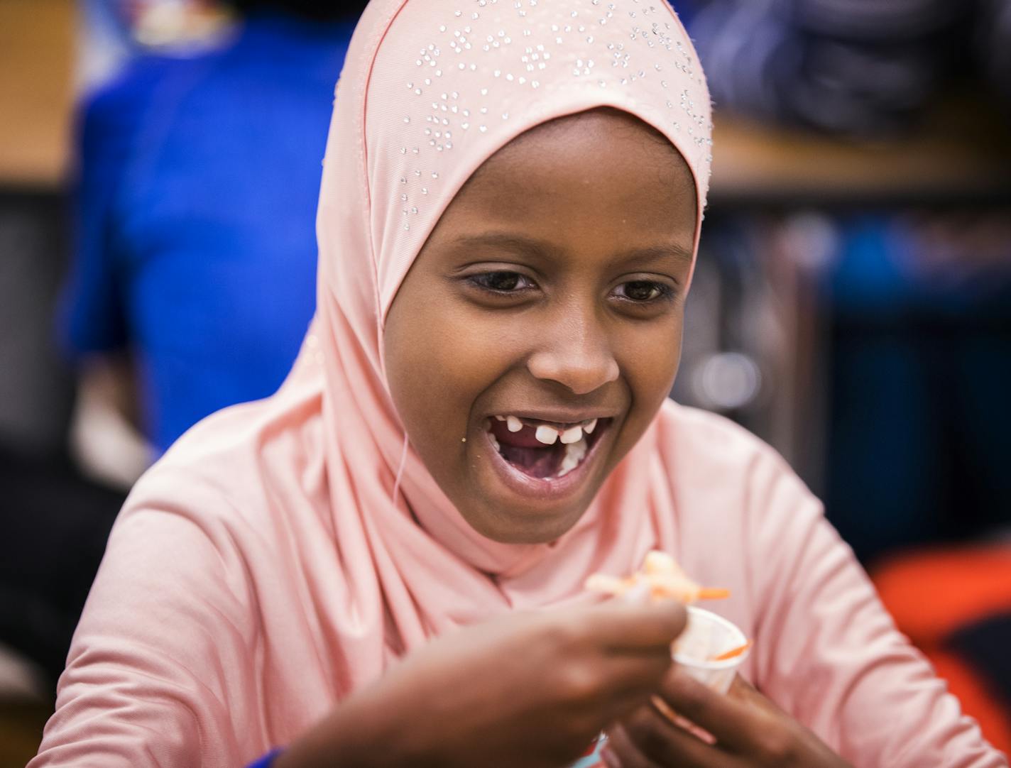 Cafeteria critics: Lyndale Elementary second-grader Josselin San Martin Munguia, top left, sat next to her friend Siclali Valles Mendoza as she reacted to the spice level in Kid Kimchi. Second-grader Jude Kresl, lower right, said the dish set his mouth on fire. Sahuur Abdi, right, reached for milk after the spicy kimchi.