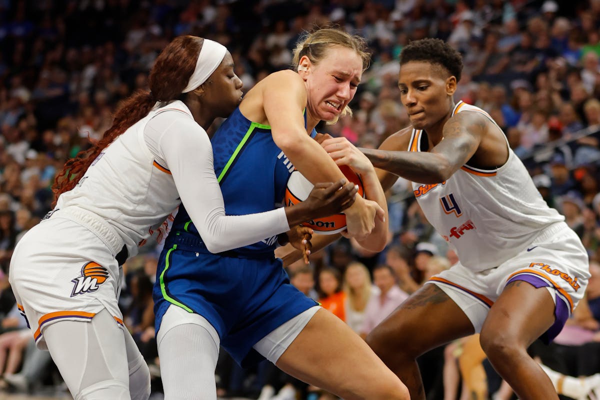 Lynx center Alanna Smith, center, secures a rebound as Mercury guard Kahleah Copper, left, and forward Natasha Mack try to take it from her on June 22