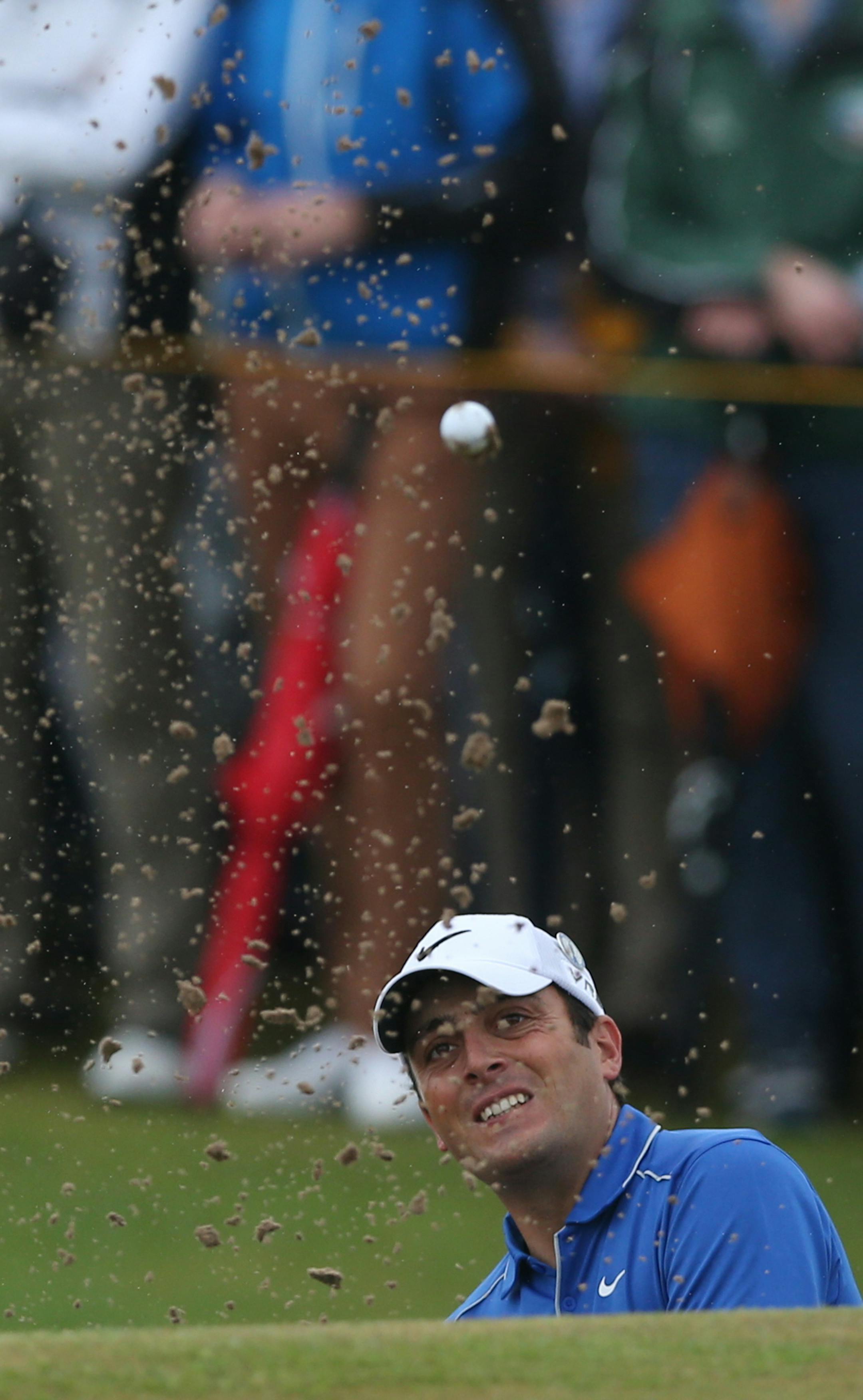 Francesco Molinari of Italy plays out of a bunker onto the 6th green during the third day of the British Open Golf championship at the Royal Liverpool golf club, Hoylake, England, Saturday July 19, 2014. (AP Photo/Jon Super)