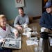 Teresa Mauer and sons Jake, Bill and Joe pored over old yearbooks that documented her athletic achievements over breakfast at the Copperfield in Mendo
