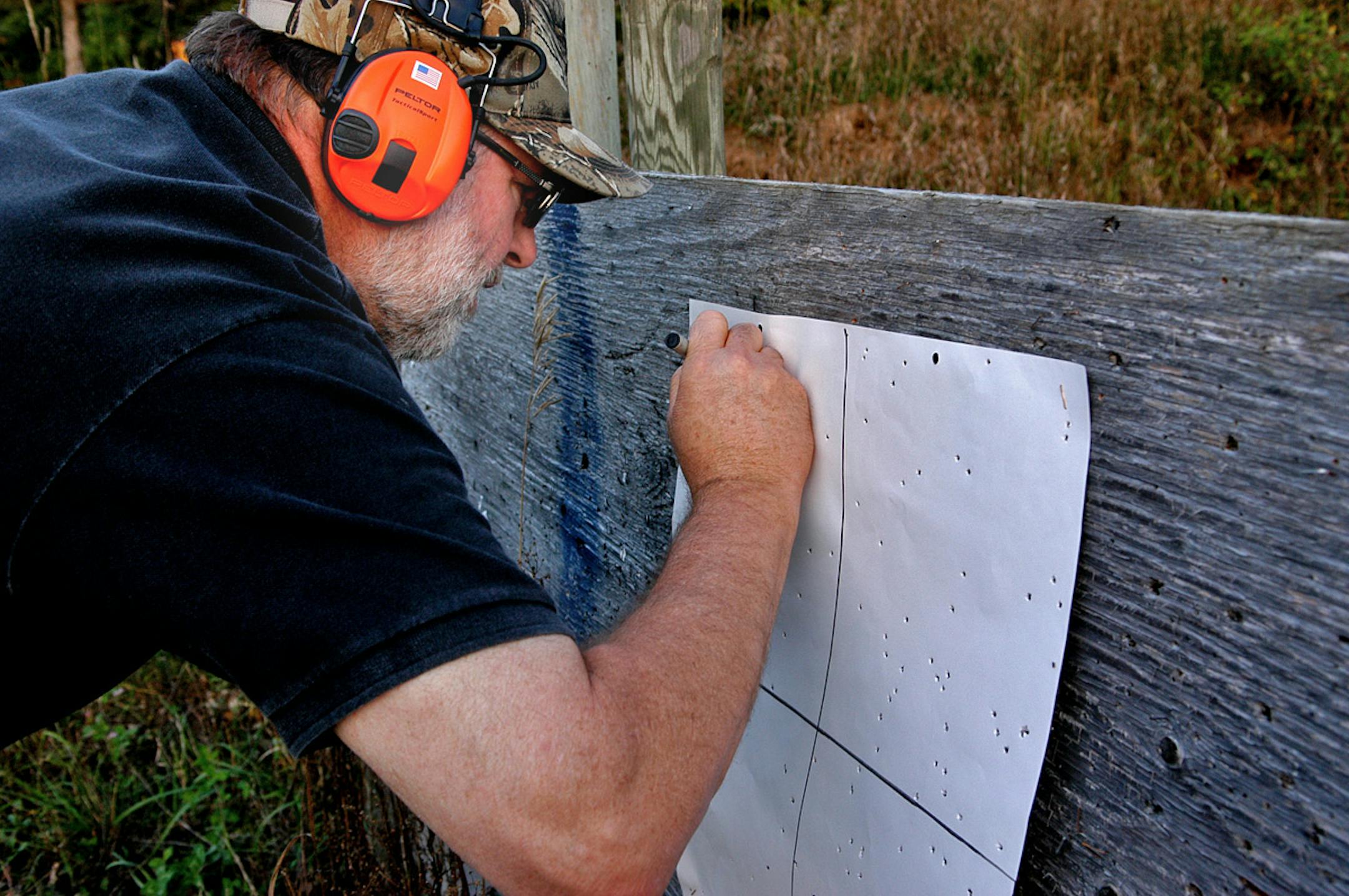 Brett Bader of Somerset Wis., marks a patterning sheet, noting the load, gun and choke that produced the pellet holes in the paper. This sheet measured about 20 inches square.