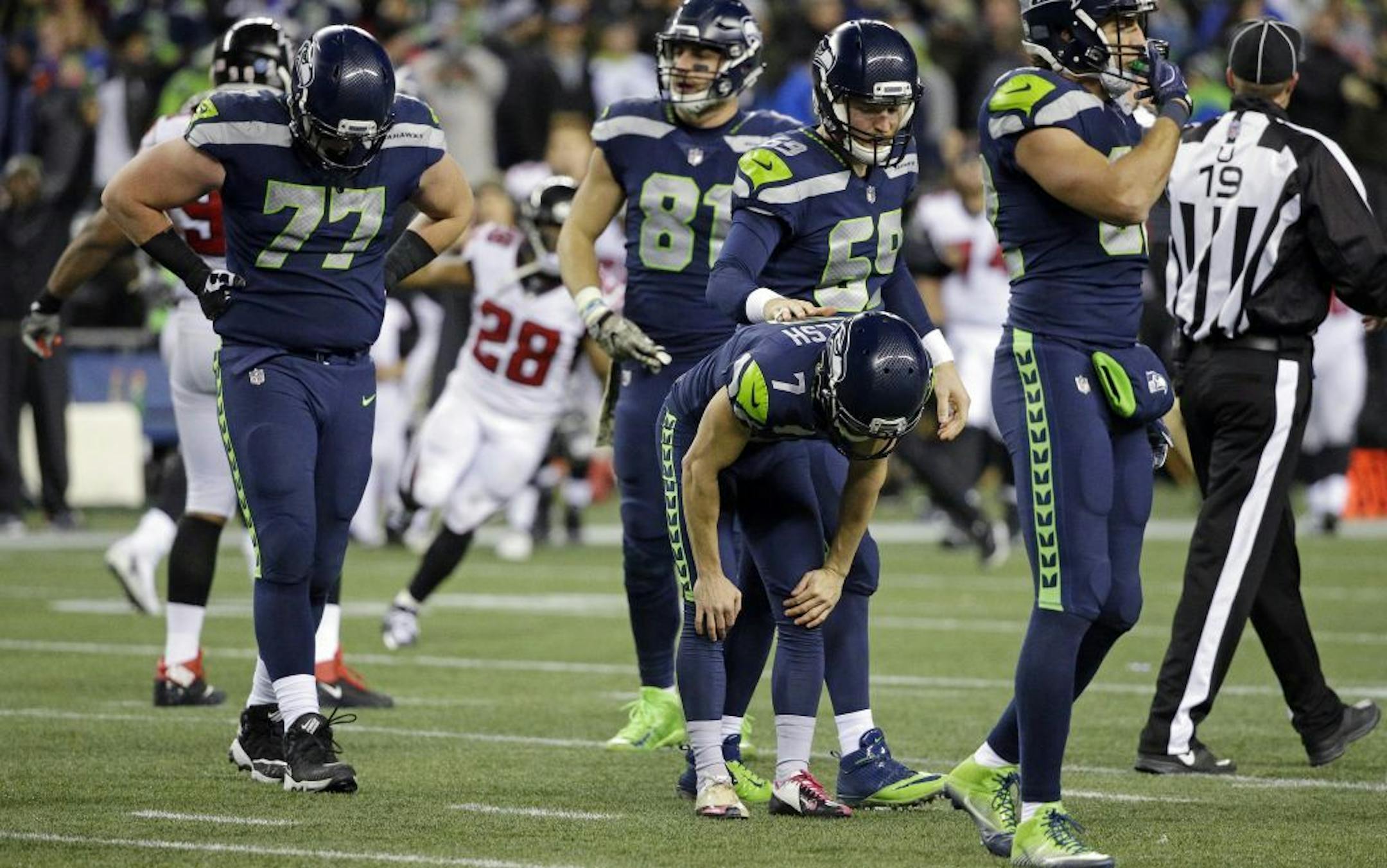 Seattle Seahawks kicker Blair Walsh (7) gets a pat from Josh Forrest after Walsh missed a field goal against the Atlanta Falcons at the end of the second half of an NFL football game, Monday, Nov. 20, 2017, in Seattle.