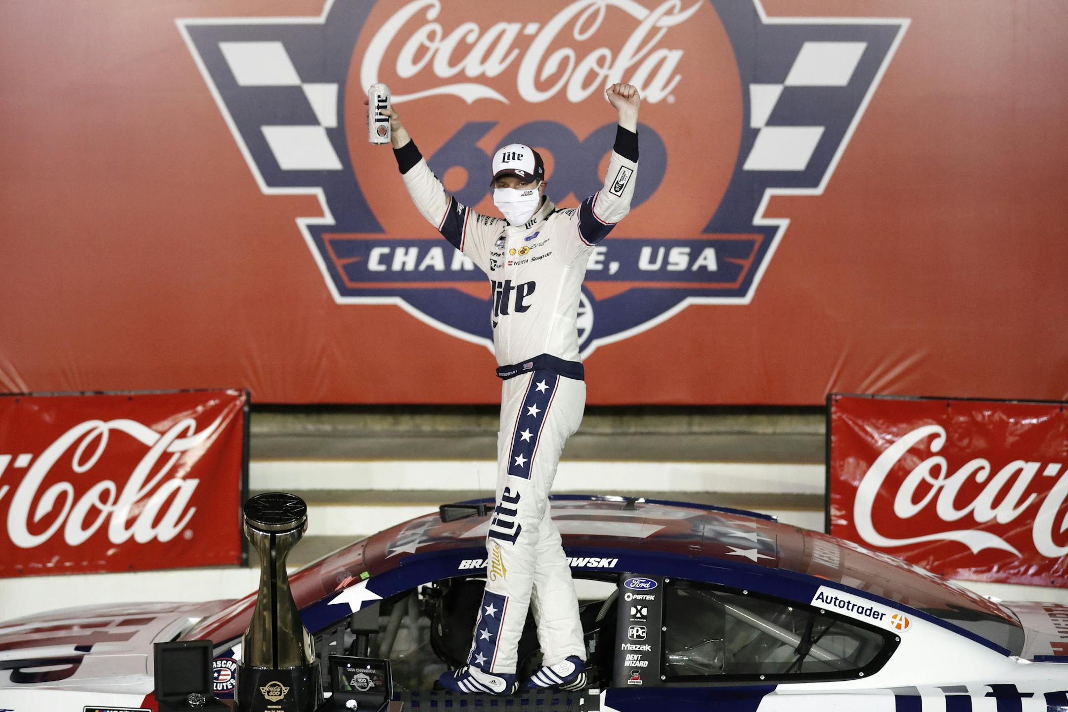 Brad Keselowski celebrates after winning the NASCAR Cup Series auto race at Charlotte Motor Speedway early Monday, May 25, 2020, in Concord, N.C. (AP Photo/Gerry Broome)