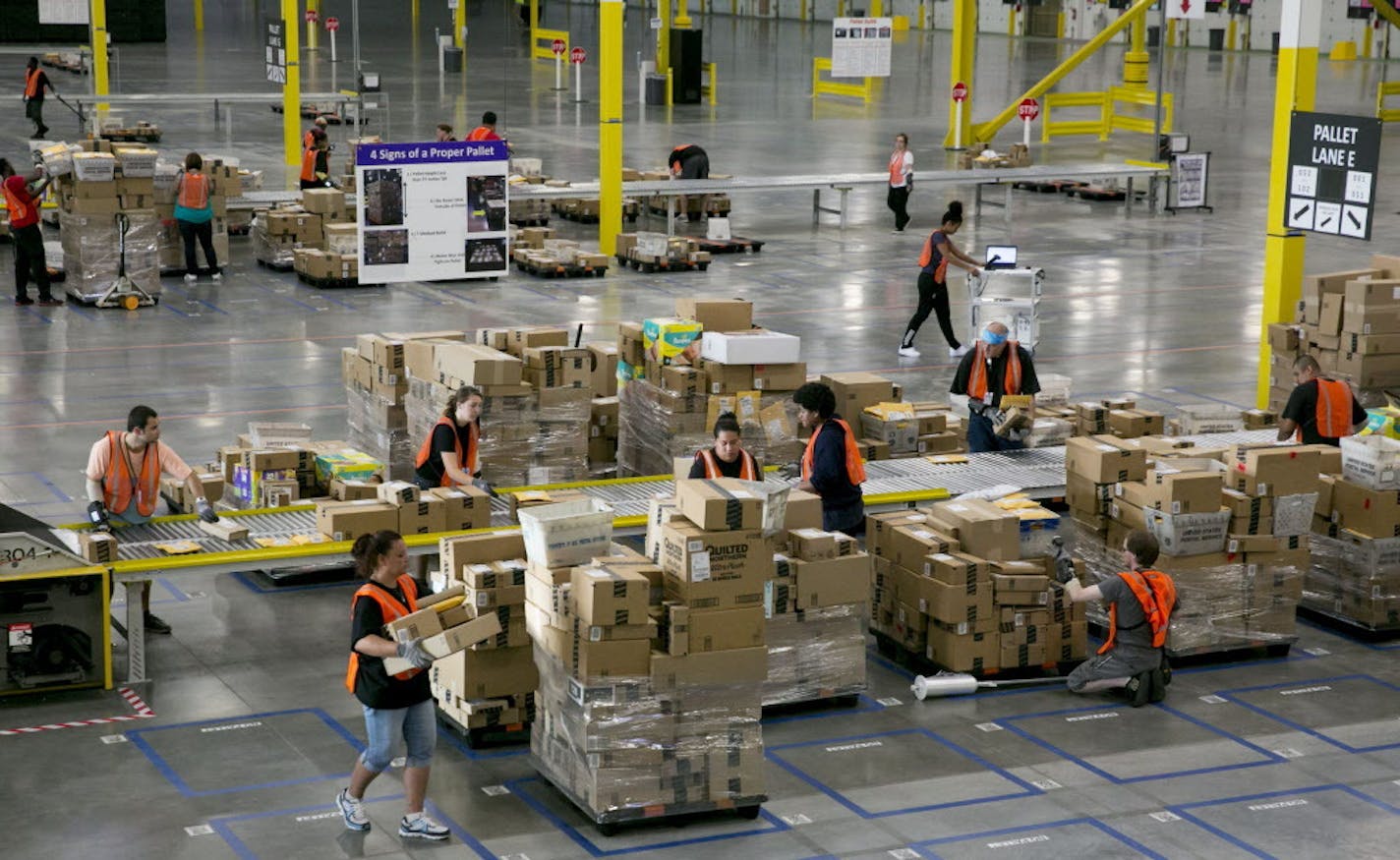 Amazon workers in the new 300,000-square-foot sortation center in Kent, Wash., sort packages by ZIP codes, place them on pallets and deliver them to local post offices between 6 a.m. and 8 a.m. for delivery in that day's mail. (Erika Schultz/The Seattle Times/MCT) ORG XMIT: 1155291